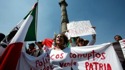 Demonstrators display messages against corruption and fascism during a protest against U.S. President Donald Trumps proposed bor